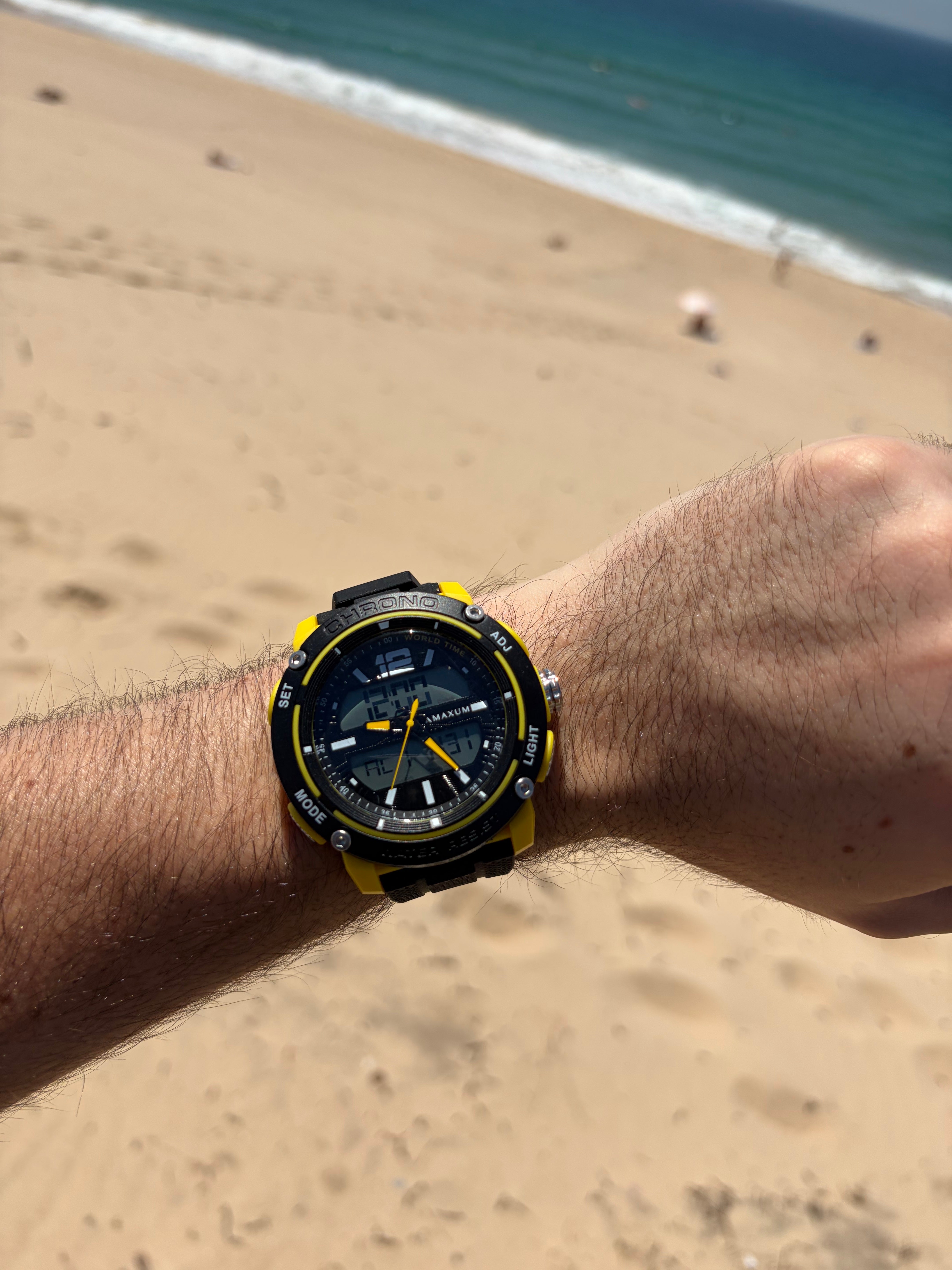Maxum Conquest Analogue Digital Watch Black & Yellow with a silicone band and a digital display. On wrist at beach