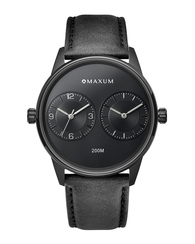 Maxum x Taylor Steele collab- black analog watch with a black dial, black case, and black leather band, branded with 'MAXUM' on the top and indicating '200M' water resistance.