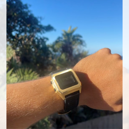 Maxum x Kyuss King Raglan Gold Tide Watch with black strap  on a wrist with a blurred natural background