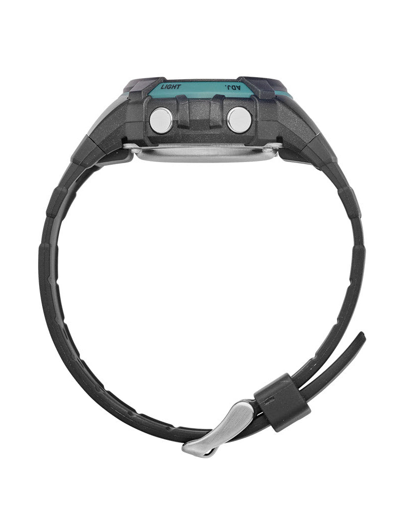 Maxum Button digital watch with a black resin strap and black case, featuring blue accents and a digital display. Side view